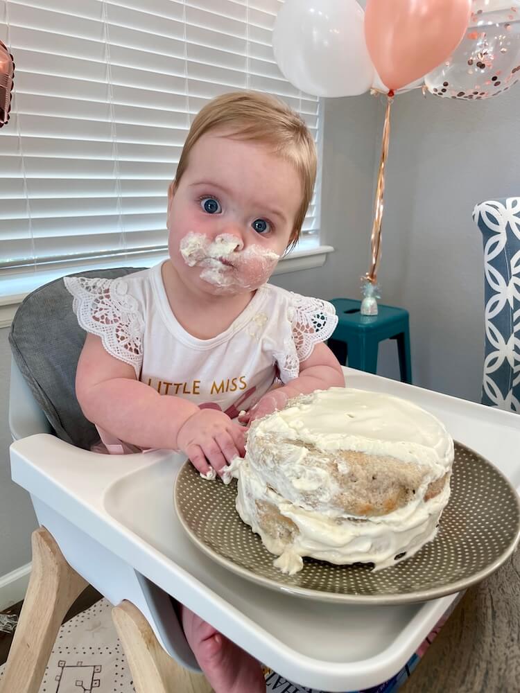 Baby with Frosting on Face from Healthy Smash Cake Recipe for First Birthday